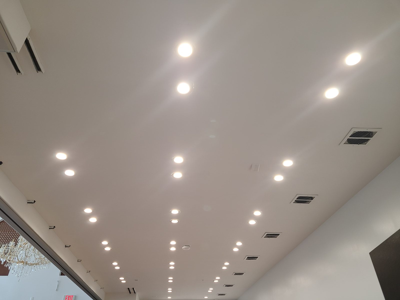 Angled ceiling fitted with rows of recessed downlights