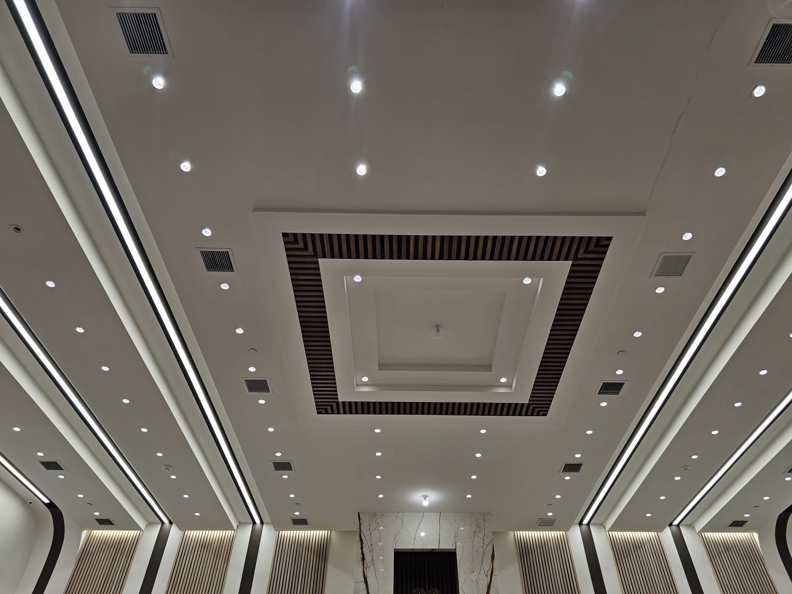 Layered ceiling with a square LED-lit frame and recessed downlights