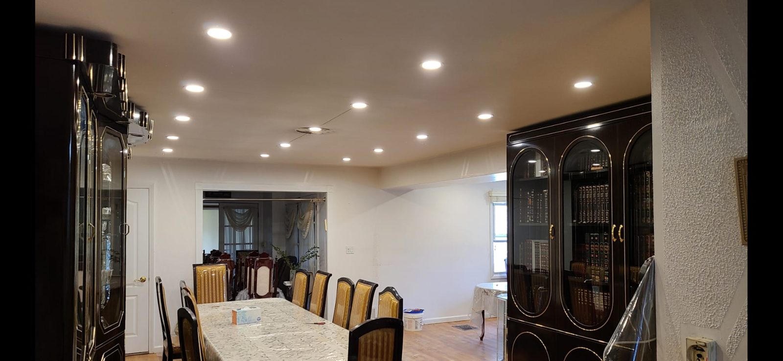 Long dining room with a column and evenly spaced recessed ceiling downlights