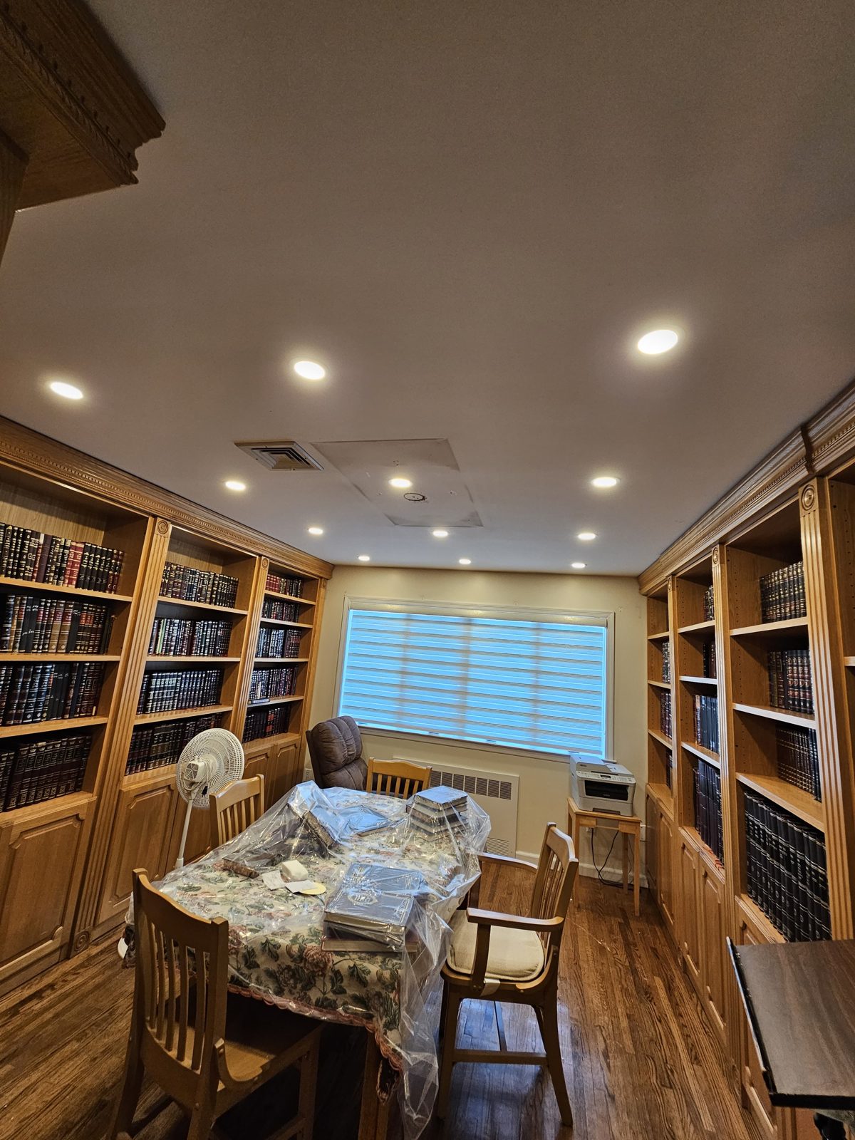 Library dining room with bookshelves and warm recessed downlights