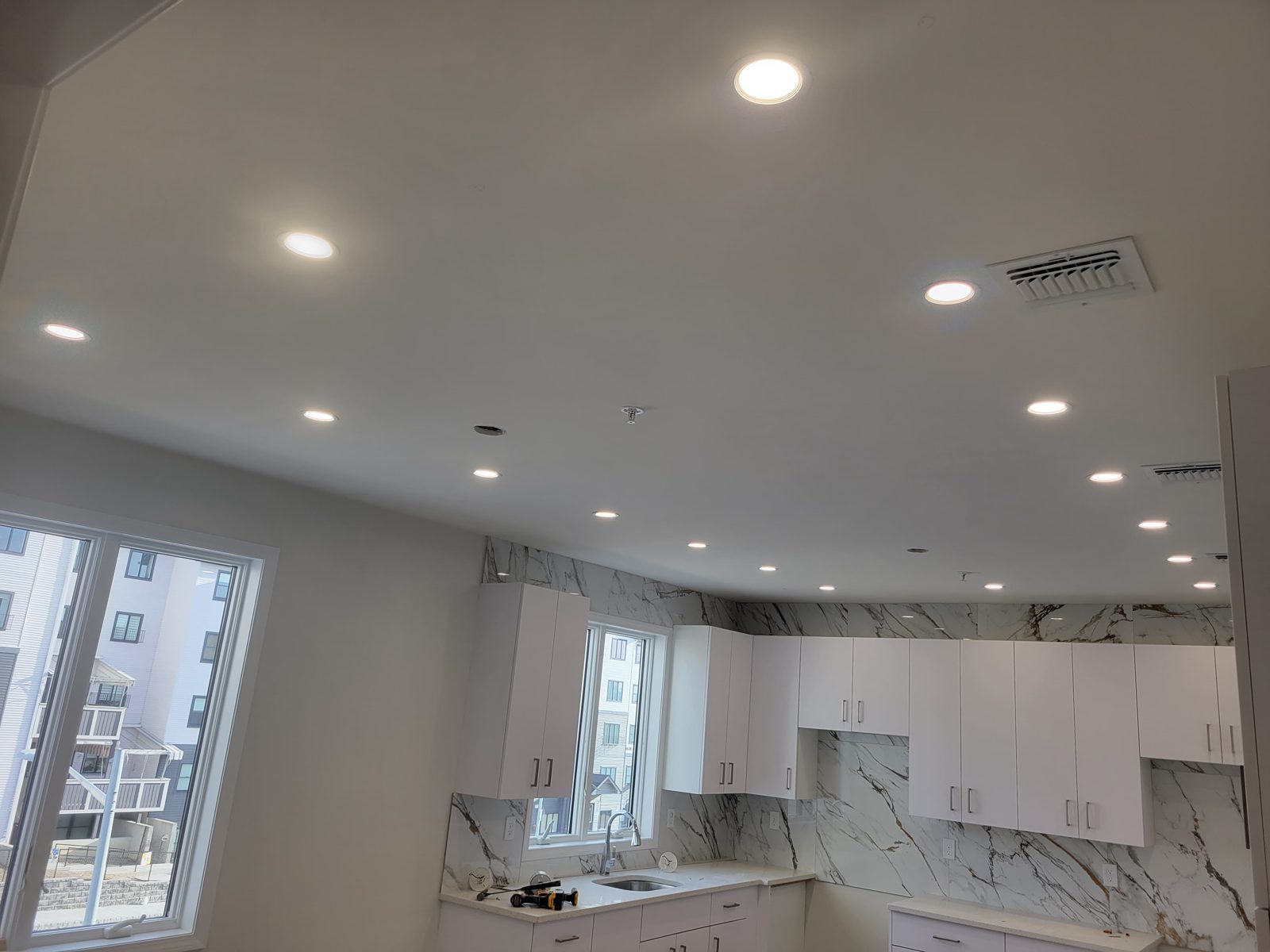 Marble kitchen counter under recessed ceiling downlights