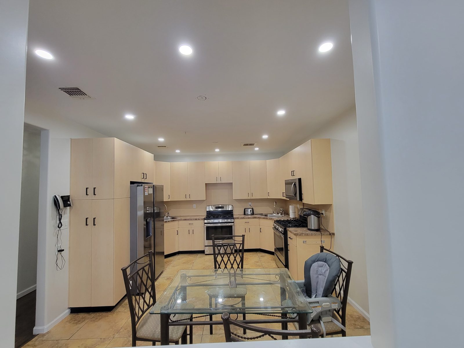 Open kitchen and dining space with recessed downlights across the ceiling
