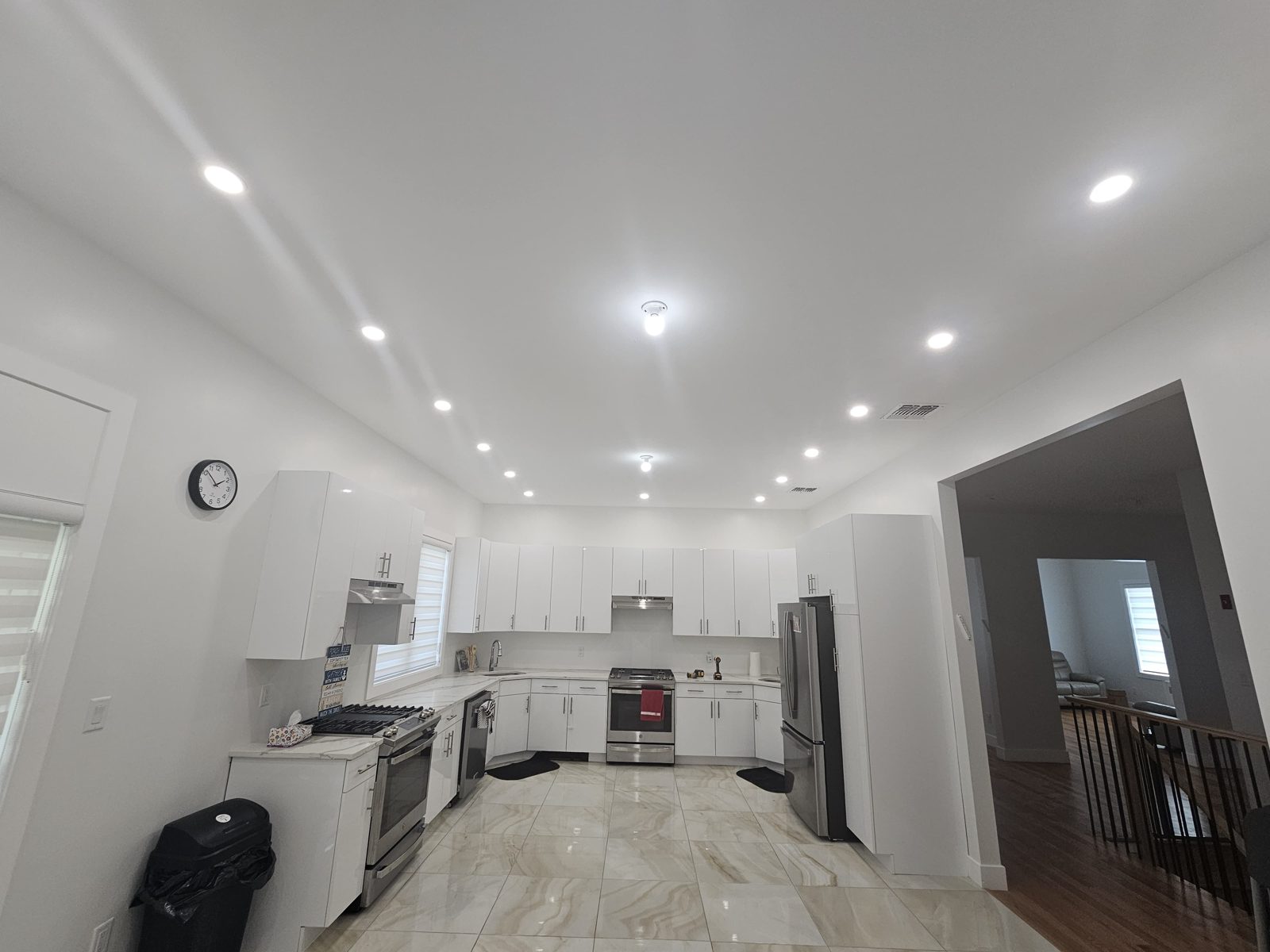 Kitchen under installation with a grid of recessed ceiling downlights