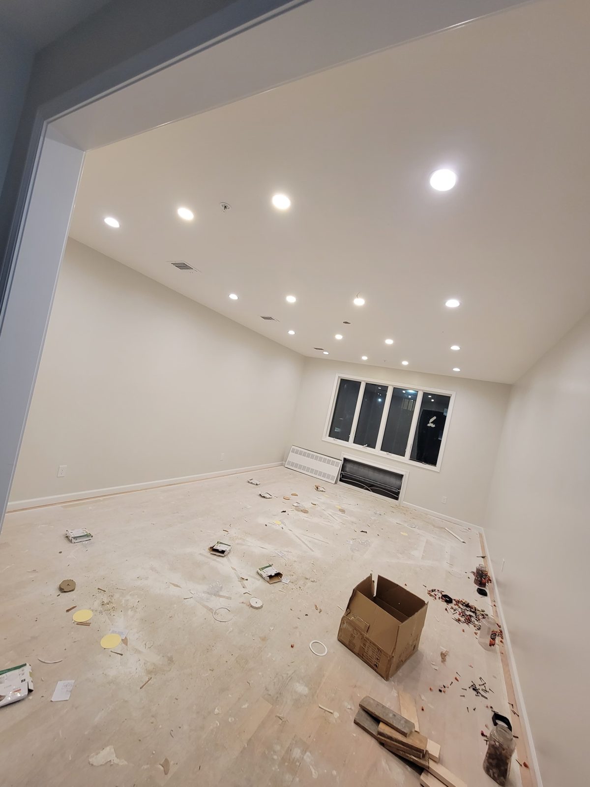 Empty room after installation showing recessed downlights across the ceiling