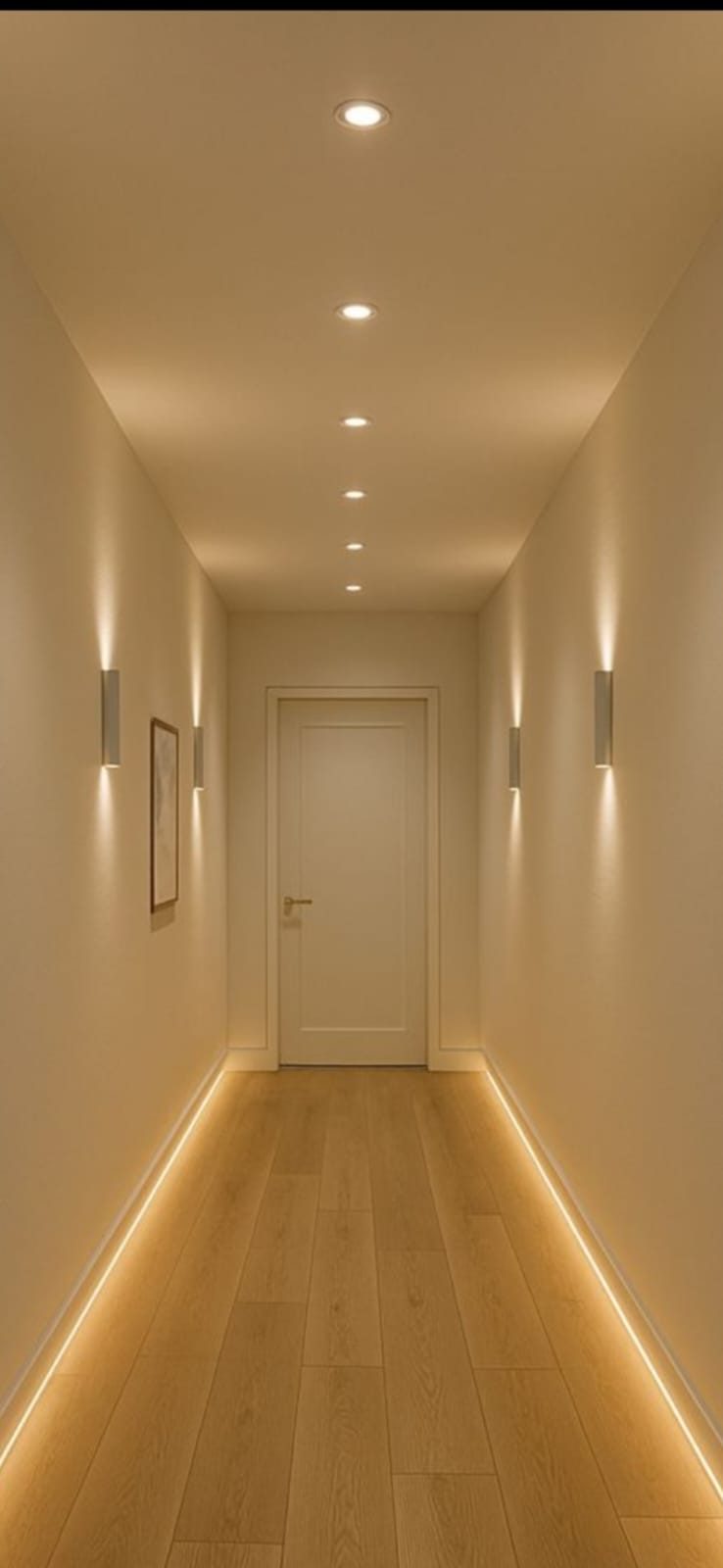 Corridor with concealed LED cove lighting glowing along the floor